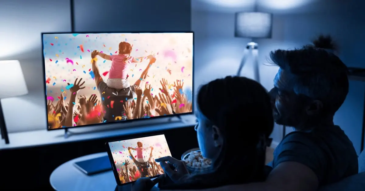smart tv features in kenya: People watching smart tv in living room at night